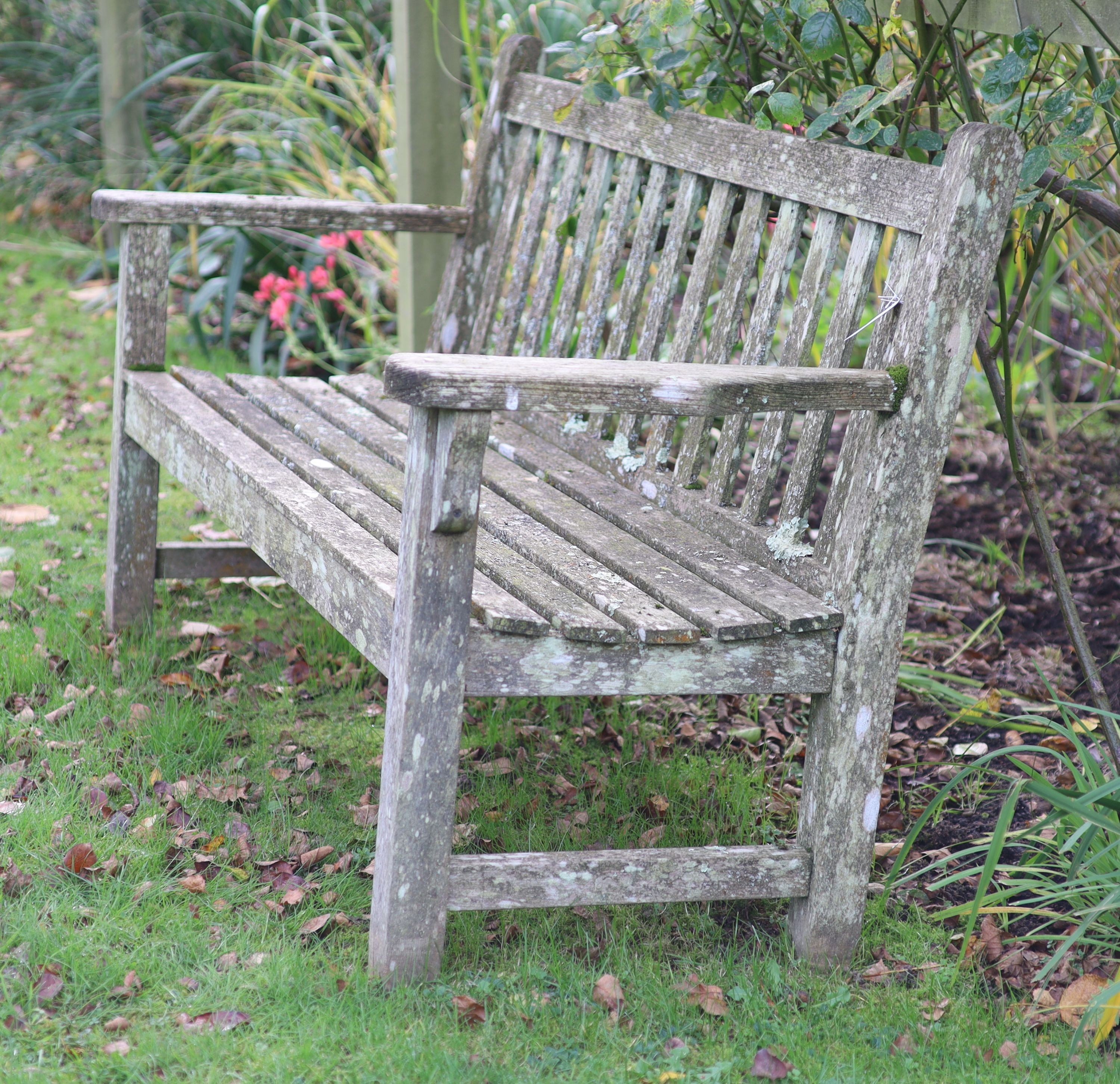 A pair of weathered teak garden benches, width 158cm